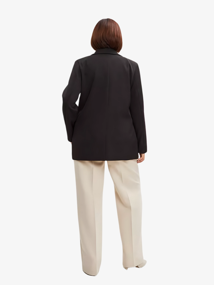 Elegant oversized black blazer styled with neutral trousers Tailored for women