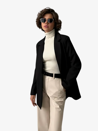 Women's cropped black oversized blazer styled with neutral trousers